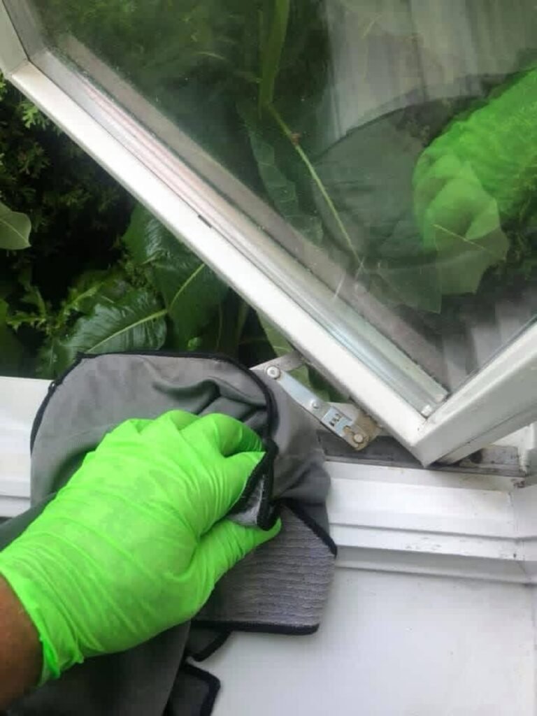 Close-up of detailed window frame wiping by Naples Window Cleaning LLC